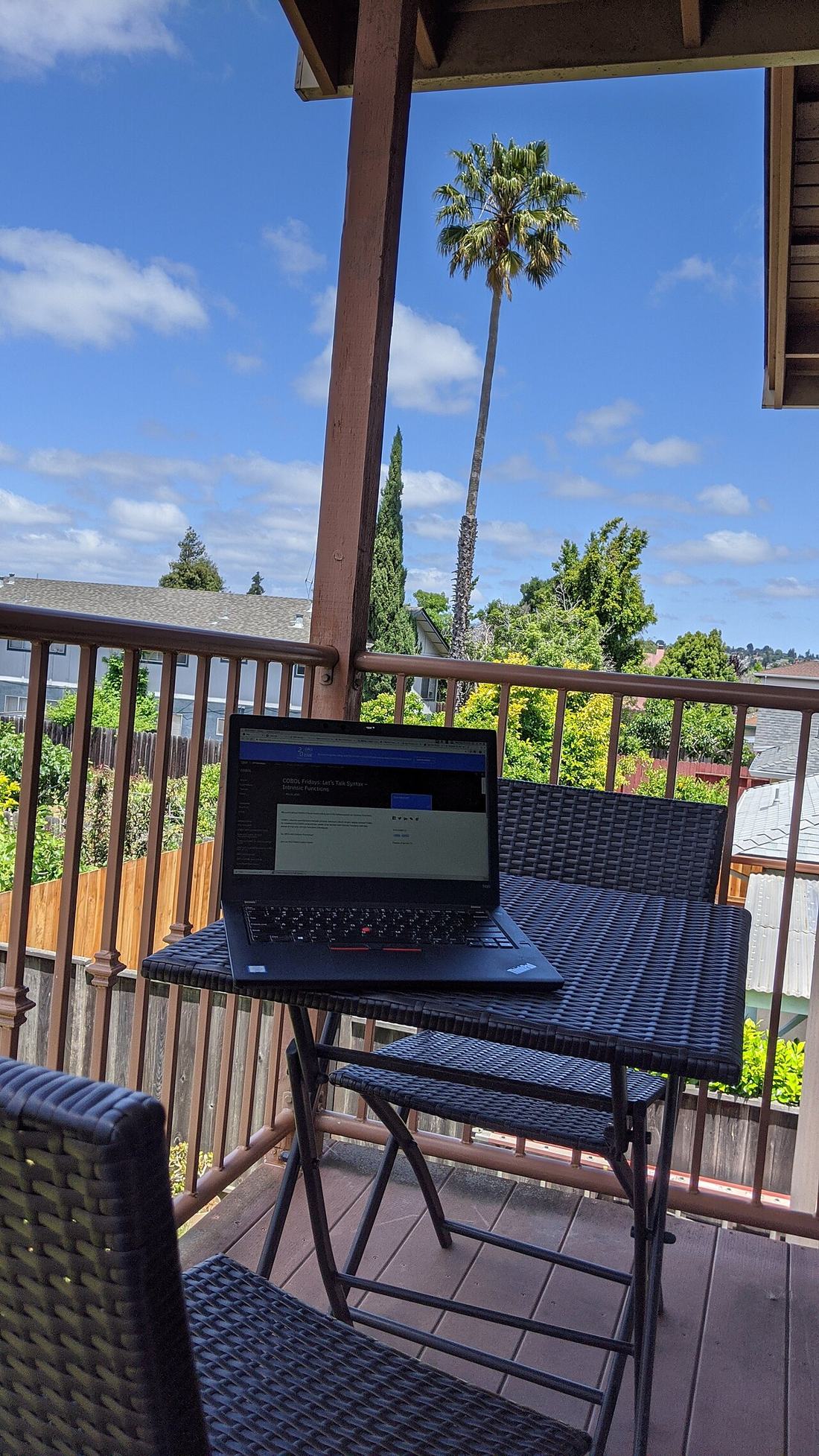 A laptop on a desk in shadow
