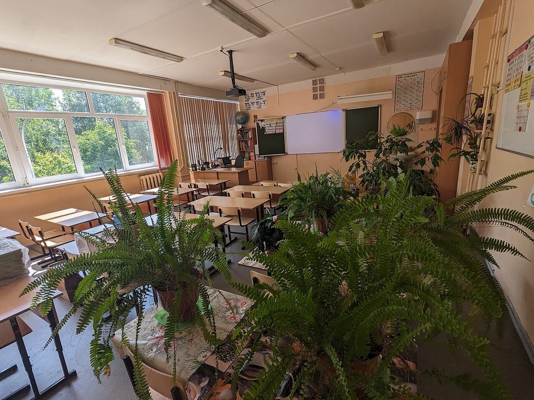 An empty classroom with a blackboard